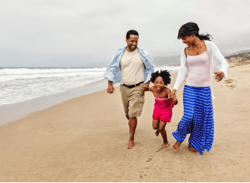 Black family walking on a beach